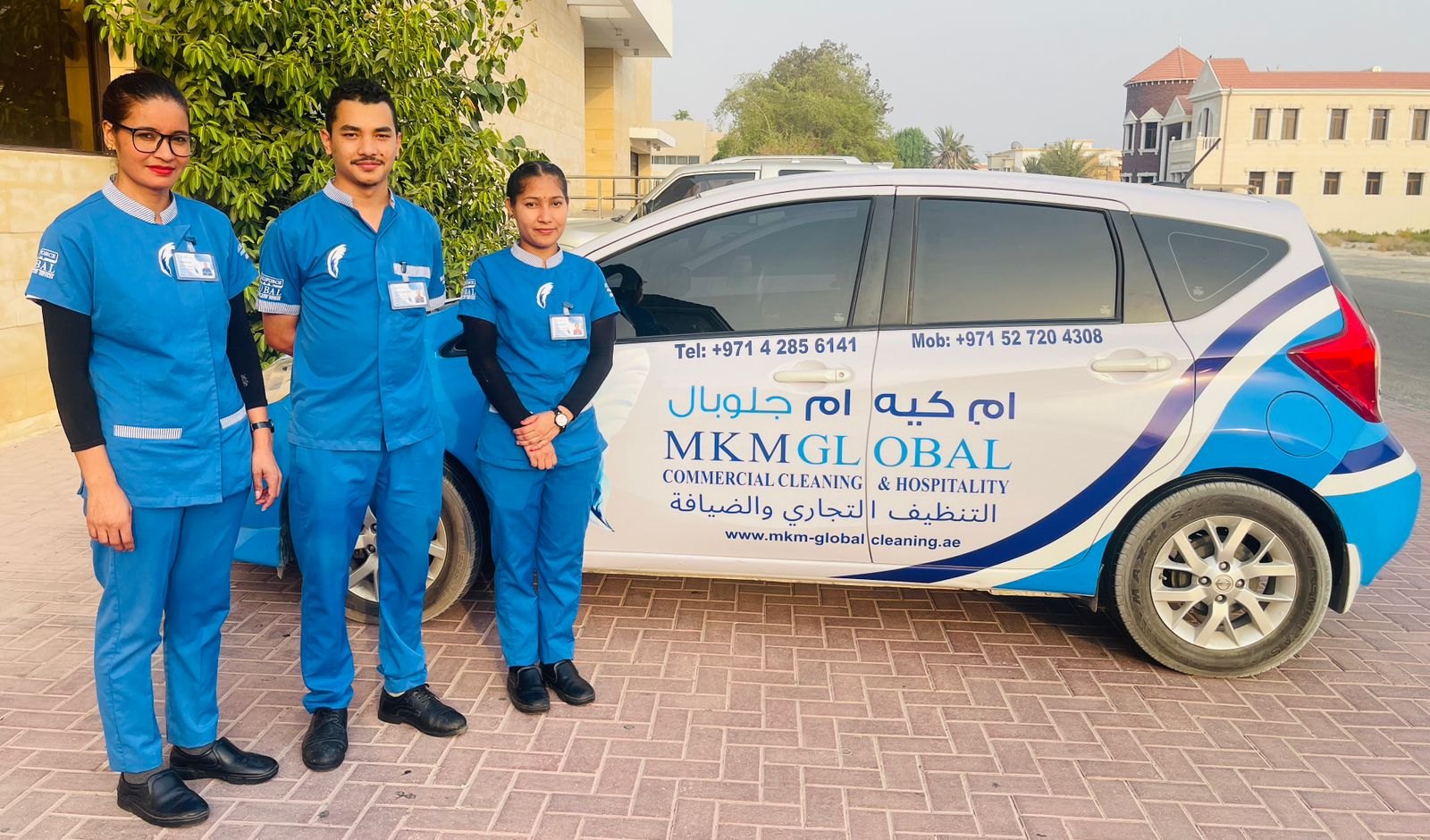 MKM Global cleaning team beside branded service vehicle