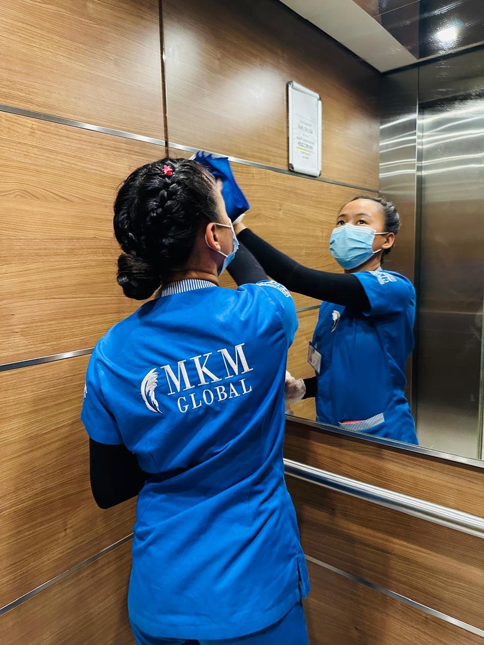 MKM Global professional cleaning a large window